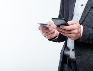 a businessman using his phone to pay online